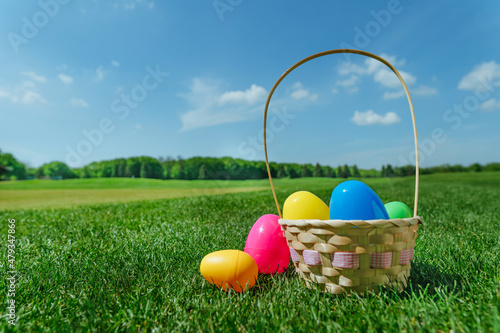 Colorful Easter eggs lying on the green grass outdoor