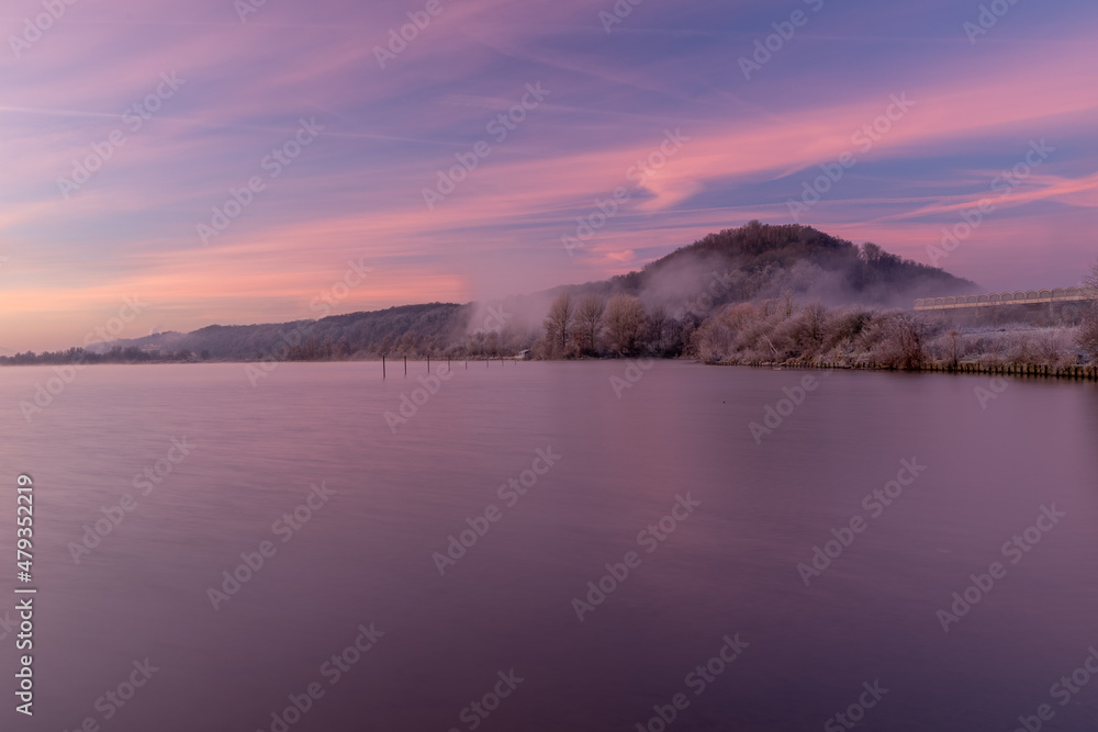 Mountain in Maastricht on an early winter morning during sunrise with amazing pastel colors. The mountain is covered with veils of fog creating a magical environment Mountain in Maastricht on an early winter morning during sunrise with amazing pastel colors. The mountain is covered with veils of fog creating a magical environment