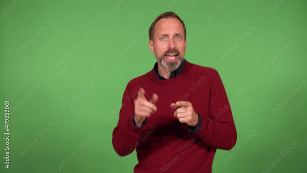A middle-aged handsome Caucasian man dances and looks at the camera - green screen background A middle-aged handsome Caucasian man dances and looks at the camera - green screen background