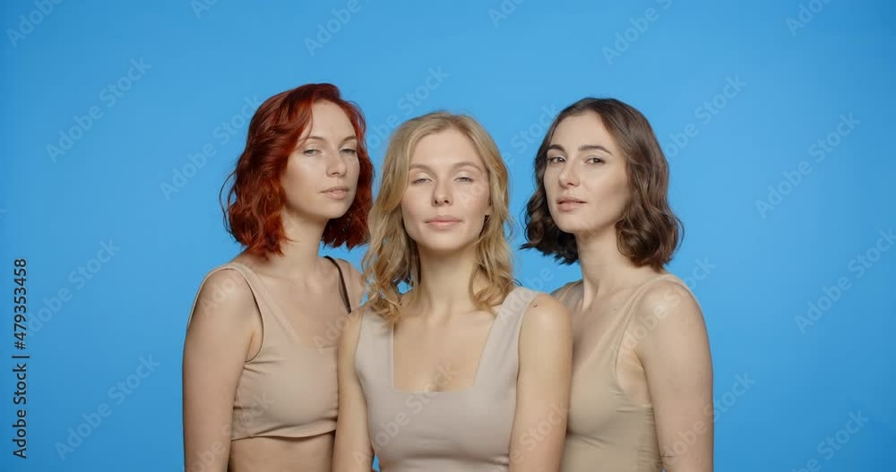 Blonde, redhead and dark haired woman are looking and smiling to the camera, portrait of different types of women in the blue screen, 4k 24p Prores Blonde, redhead and dark haired woman are looking and smiling to the camera, portrait of different types of women in the blue screen, 4k 24p Prores