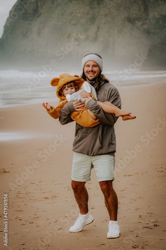 men playing with her daughter on the beach in Portugal Algarve fatherlove photo