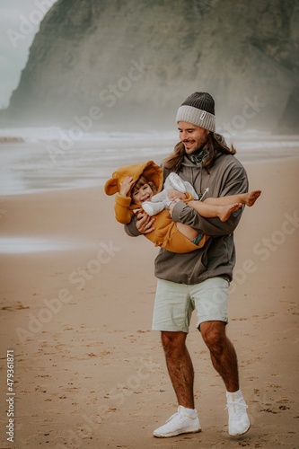 men playing with her daughter on the beach in Portugal Algarve fatherlove
