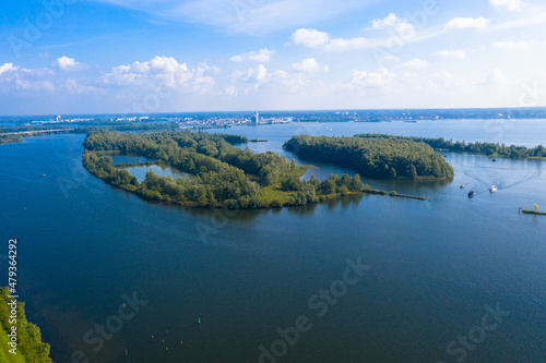 Aerial view of the Wolderwijk lake with small green islands that offer shelter to various species of fish and birds. Dutch province of Flevoland, Netherlands.