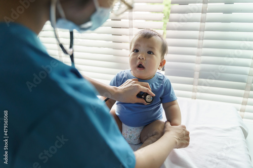 Asian Pediatrician examining and listening lungs of little baby with stethoscope