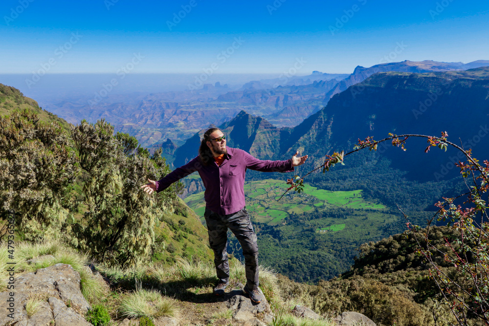Naklejka premium White Man Tourist posing on the Green Valley of Simien Mountains near Gondar, Northern Ethiopia