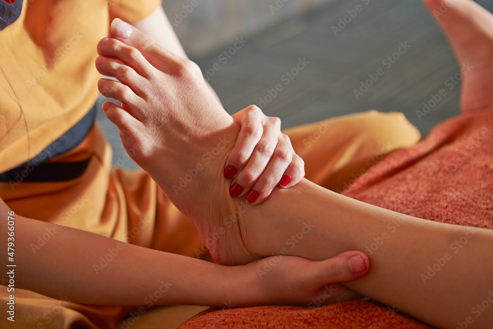 Close-up of hands massaging feet	