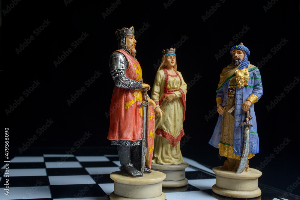 chess pieces on board on black background