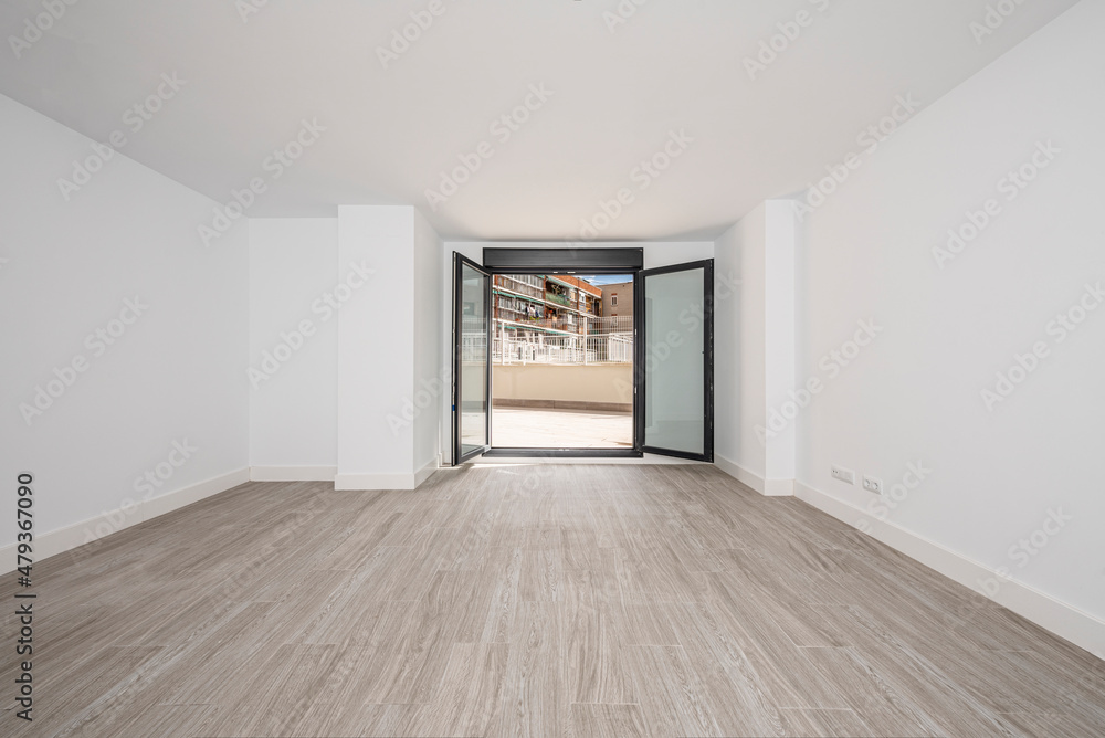 Room with freshly painted white walls with ceramic floors, front door and large window that opens to a patio. Room with freshly painted white walls with ceramic floors, front door and large window that opens to a patio.