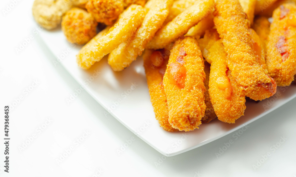 Southern fried and roast chicken bites, onion rings and mozzarella stick served on the white plate Southern fried and roast chicken bites, onion rings and mozzarella stick served on the white plate