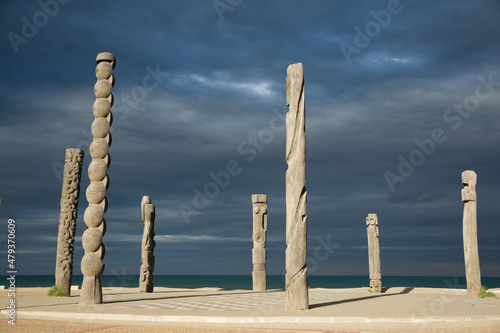 Sunlit Weathered Wooden Totems in Front of the Medirranean Sea in Le Barcares France