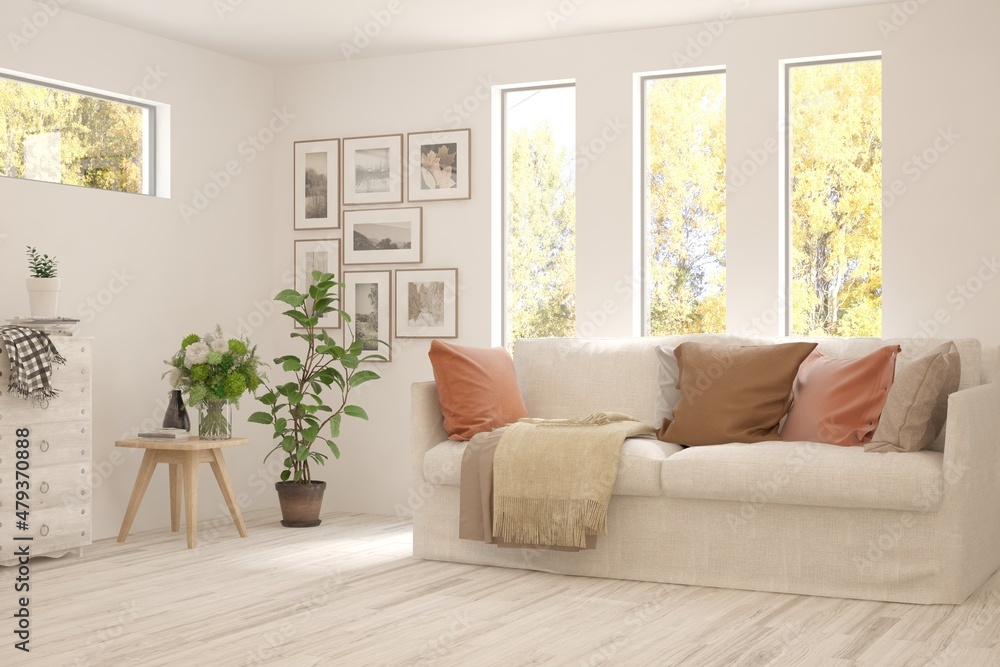 Fototapeta premium Stylish room in white color with sofa and autumn landscape in window. Scandinavian interior design. 3D illustration