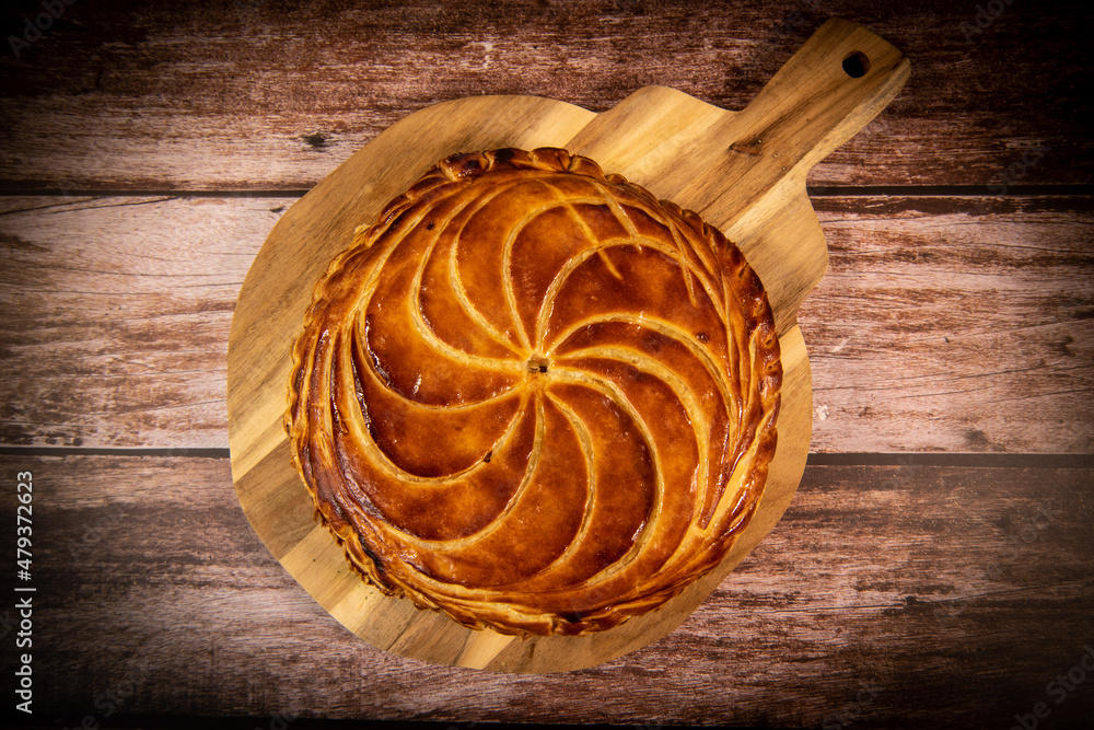Galette des rois on wooden table, Traditional Epiphany cake in France. High quality photo Galette des rois on wooden table, Traditional Epiphany cake in France. High quality photo