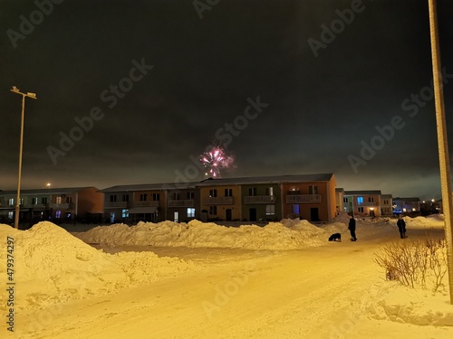 New Year's fireworks in the cottage village on a winter night photo