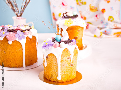 Traditional Easter cake sweet bread kulich decoratedwith candies. sugar flower, meringue icing photo