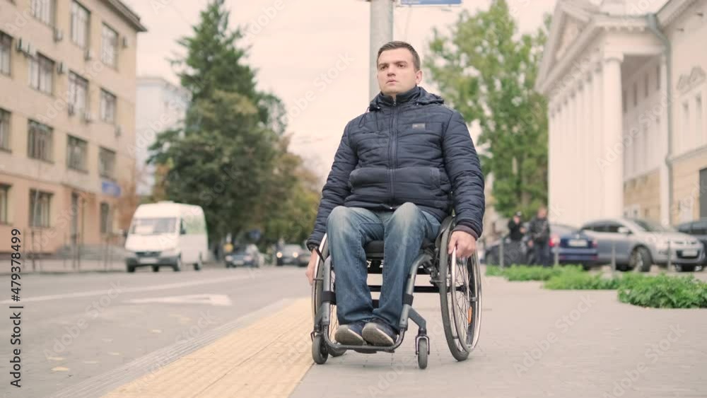 Person with a physical disability waiting for city transport with an accessible ramp Person with a physical disability waiting for city transport with an accessible ramp