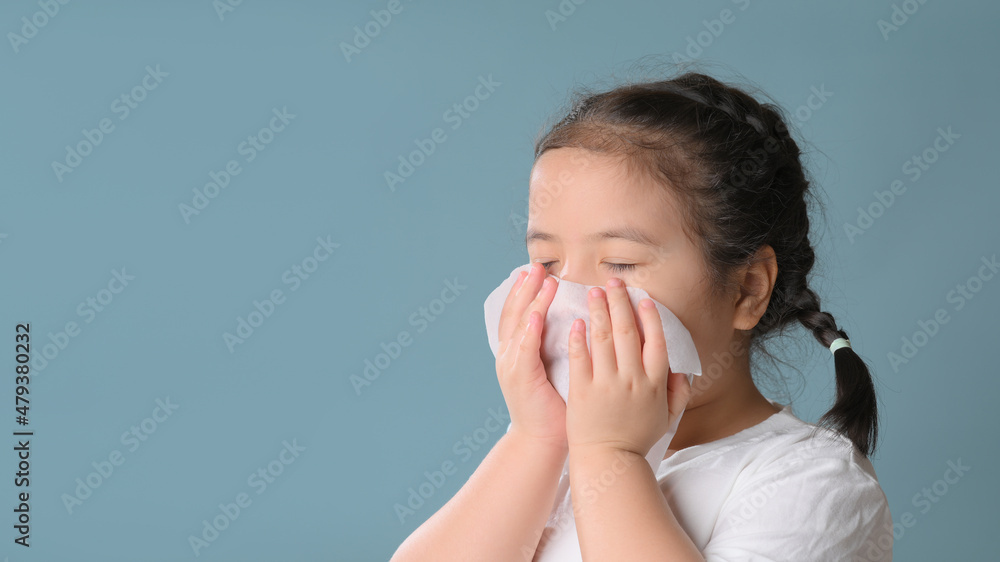 Little asian child girl sick and sad with sneezing on nose and cold cough on tissue paper because weak or virus and bacteria from dust weather. Little asian child girl sick and sad with sneezing on nose and cold cough on tissue paper because weak or virus and bacteria from dust weather.