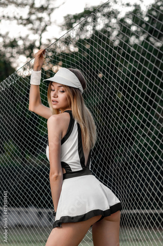 young blonde woman on the tennis court © Yura