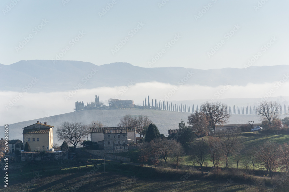 View of the Val d'Orcia in Tuscany immersed in the fog
