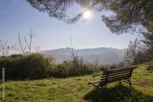 View of the Val d'Orcia in Tuscany from a bench on a sunny day