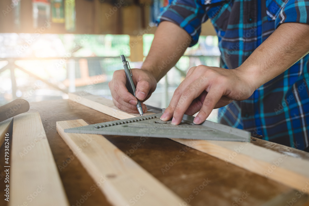 Hands of person doing diy project at home. Man measuring wood to doing cabinet craftworks as a hobby. Hands of person doing diy project at home. Man measuring wood to doing cabinet craftworks as a hobby.