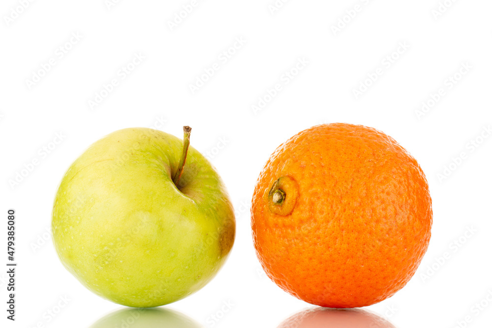 One juicy green apple and tangerine, close-up, isolated on white. One juicy green apple and tangerine, close-up, isolated on white.