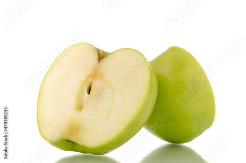 Two halves of a sweet green apple, close-up, isolated on white.
