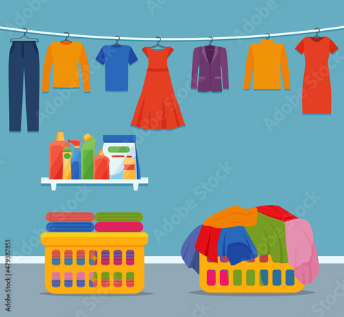 Laundry room interior with clothes and cleaning products.
