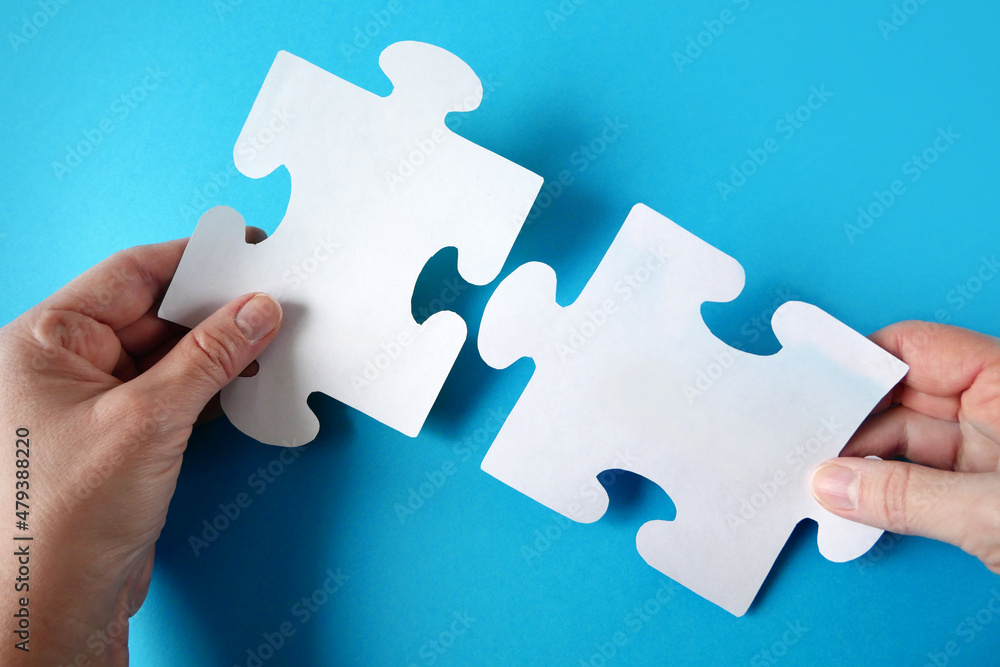 one puzzle connects to other puzzles, a puzzle in the hand of a  businessman, a business team puts together a puzzle. Jigsaw puzzle. Business  solutions, success and strategy. Stock Photo | Adobe