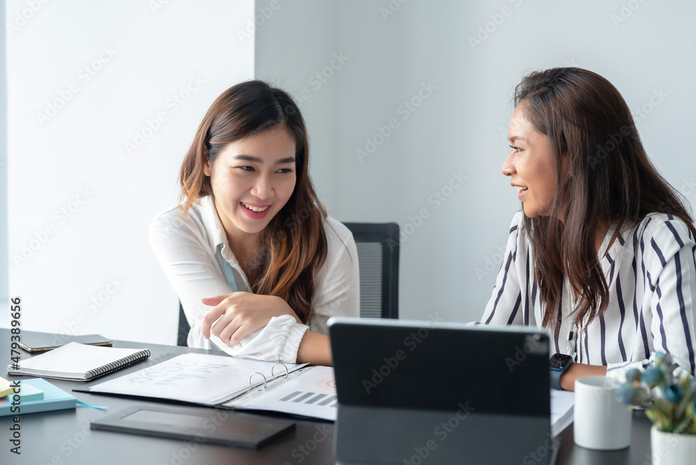 Two Young Asian businesswoman discuss with new startup project Idea presentation, analyze planning and financial statistics and investment market at office. Two Young Asian businesswoman discuss with new startup project Idea presentation, analyze planning and financial statistics and investment market at office.