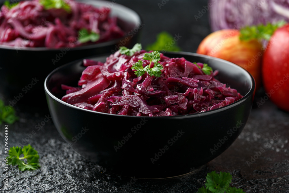 Braised Red Cabbage with apples and redcurrant in black bowl Braised Red Cabbage with apples and redcurrant in black bowl