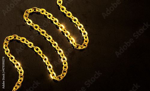 Gold jewelry. Gold chains on black background