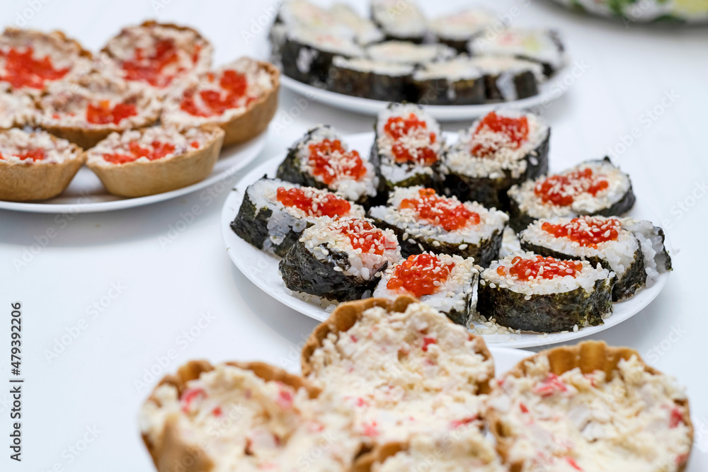 On the festive table are homemade sushi with red caviar, Japanese food. On the festive table are homemade sushi with red caviar, Japanese food.