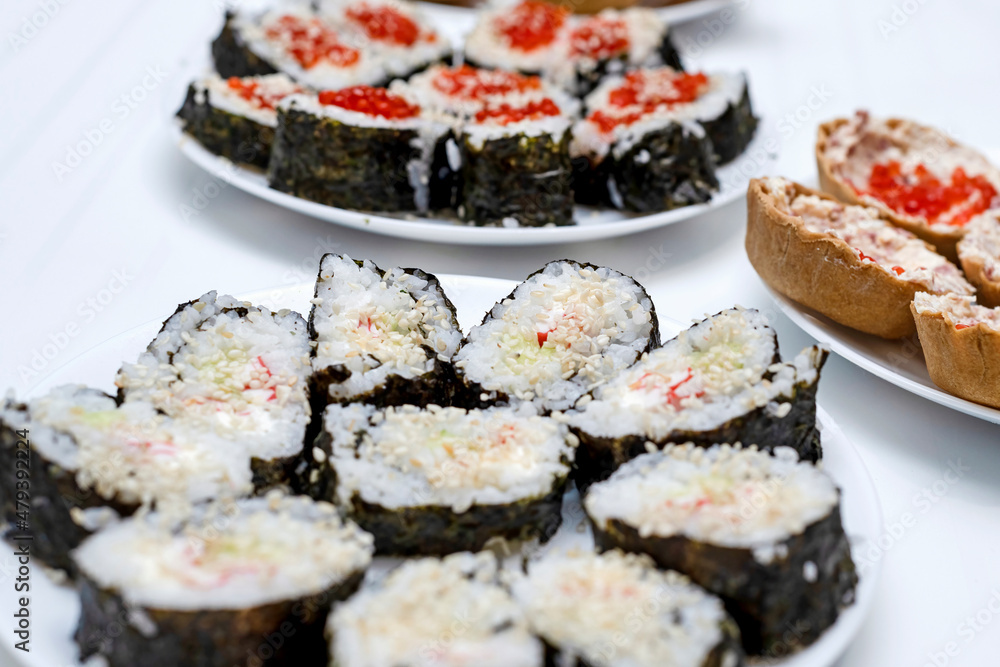 Homemade sushi on the festive table, Japanese food, holidays. Homemade sushi on the festive table, Japanese food, holidays.