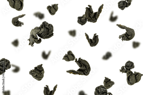 Falling Tea leaves isolated on white background, selective focus