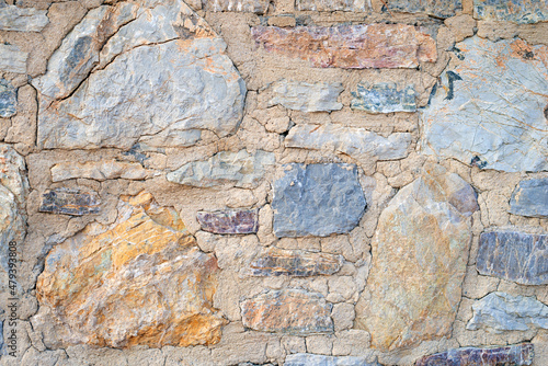 Obraz na plátně Stone wall with cracked mortar in joints