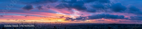 High resolution panorama image of sunrise with view over Haarlem and Amsterdam with orange and purple clouds 