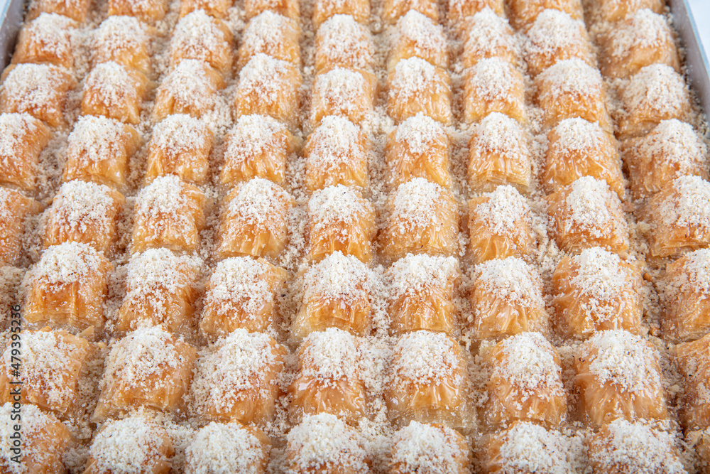 Hazelnut milky baklava served with hazelnuts around and milk on a tray