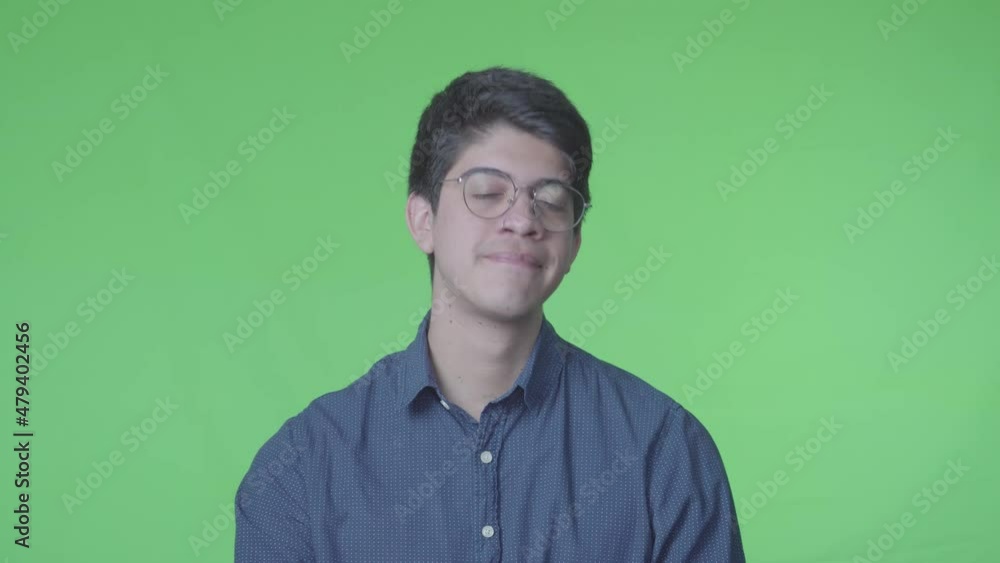 hombre latino diciendo si con la cabeza fondo verde