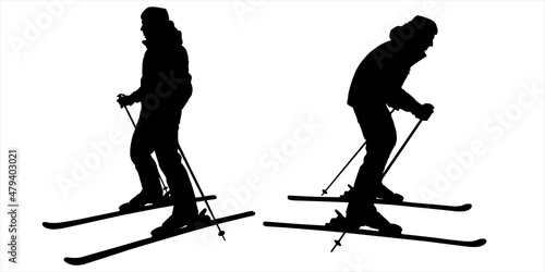 The two skiers went their separate ways to continue the competition. Man, guy skier. Skier preparing to descend from the slope. Winter sports. Two male black silhouettes isolated on white background. photo