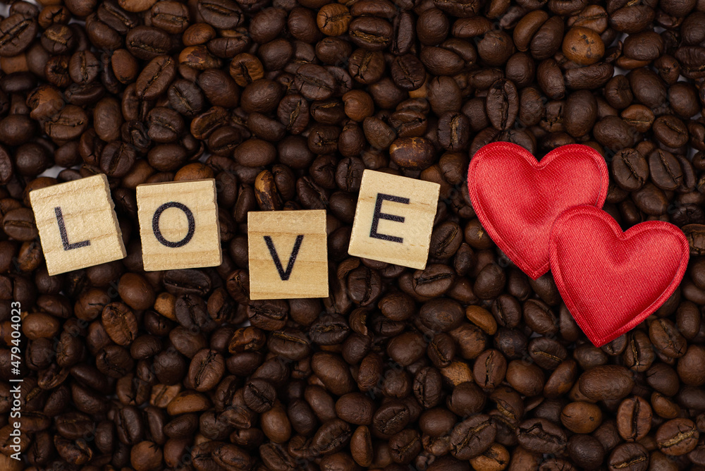 red heart and an inscription of letters on a background of coffee beans. Love coffee concept. St. Valentine's Day. View from above. red heart and an inscription of letters on a background of coffee beans. Love coffee concept. St. Valentine's Day. View from above.