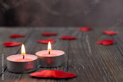 Romantic concept with candle and hearts on a wooden background. St. Valentine s Day