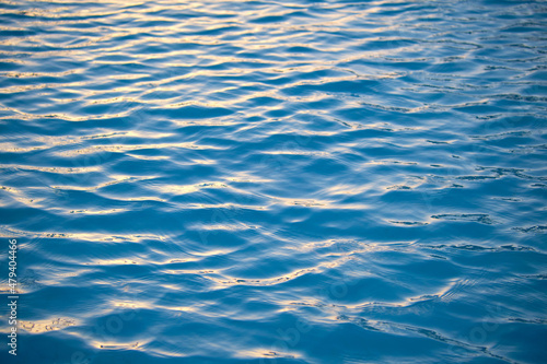 Closeup seascape surface of blue sea water with small ripple waves