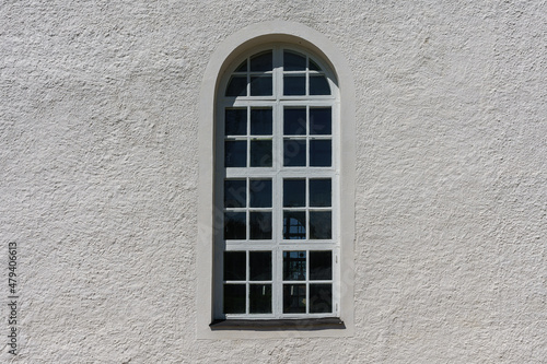 Large vaulted window on a sunny white wall
