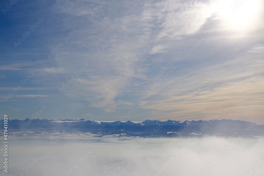 Panorama of the Tatra Mountains from Babia Gora peak in winter sunny and cloudy day. Diablak, Babiogorski National Park, Beskid Zywiecki, Poland