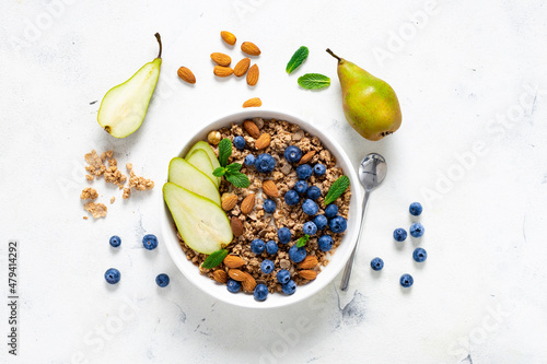 Photos Flat lay healthy breakfast with granola, natural yoghurt, fruits and blueberry b