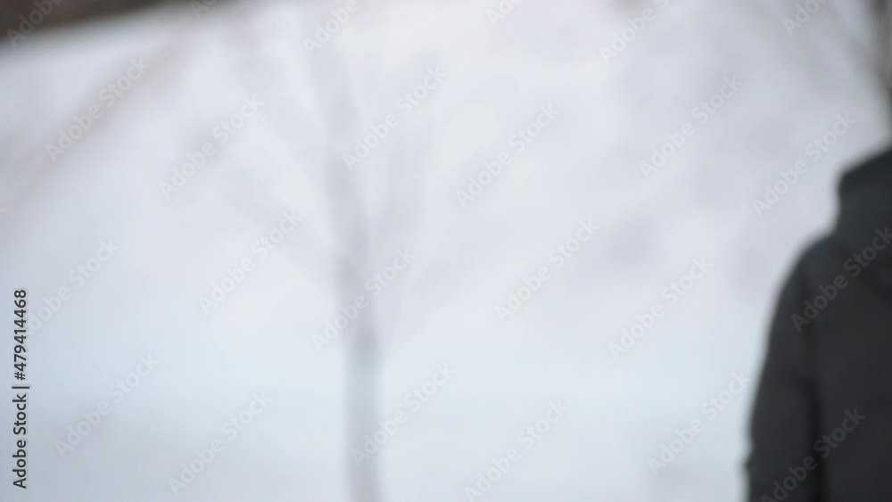 A close-up elbow greeting to avoid the spread of coronavirus (COVID-19). In winter a woman in a medical face mask meets a man on the street. Instead of greeting with a hug, they bump elbows. A close-up elbow greeting to avoid the spread of coronavirus (COVID-19). In winter a woman in a medical face mask meets a man on the street. Instead of greeting with a hug, they bump elbows.