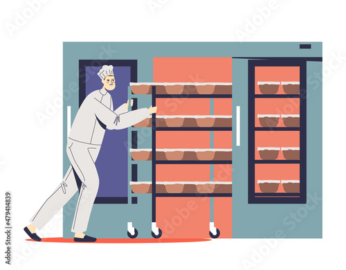 Baker in uniform taking fresh baked bread on rack from oven. Man baking pastry. Bakery production