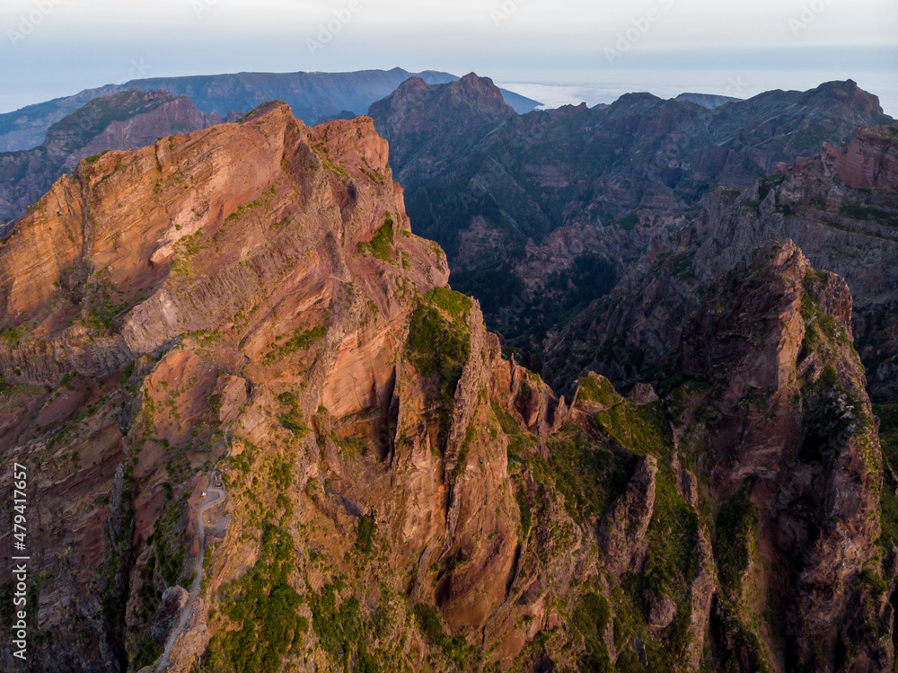 Aerial view of picturesque volcanic mountains at sunrise.