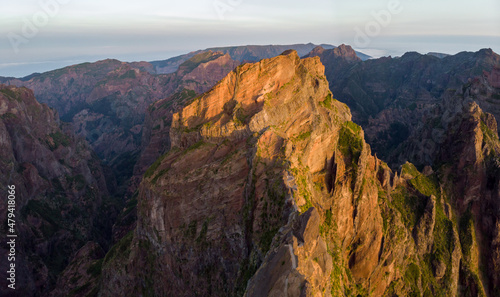 Aerial view of picturesque volcanic mountains at sunrise.