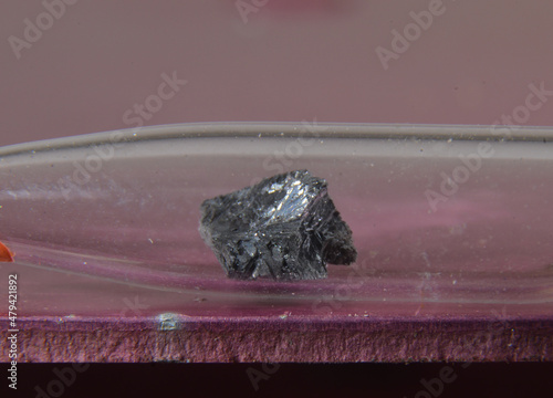 Microphoto of a sample of the periodic elementt No. 33: Arsenic. The toxic metal is stored in a glass ampoule photo